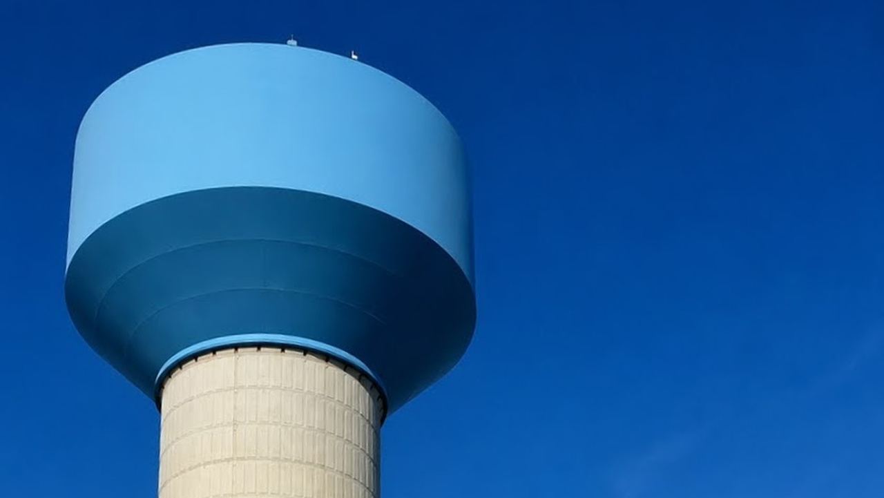 Tall elevated water storage tower that sets distribution system pressure